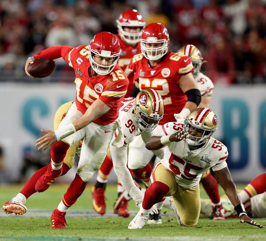 Kansas City Chiefs quarterback Patrick Mahomes breaks off a run after escaping from San Francisco 49ers defensive tackle DeForest Buckner and defensive end Dee Ford during the fourth quarter of Super Bowl LIV at Hard Rock Stadium in Miami Gardens, on Feb. 2, 2020. © Allen Eyestone/Palm Beach Post / USA TODAY NETWORK via Imagn Images