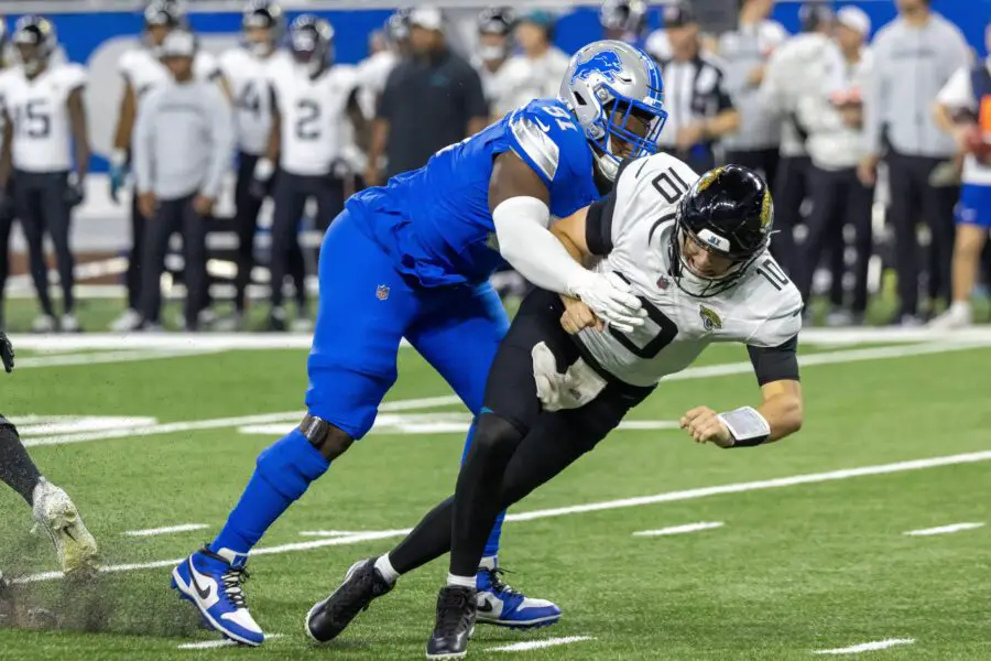Jacksonville Jaguars quarterback Mac Jones (10) passes the ball and is pressured by Detroit Lions defensive end Levi Onwuzurike (91) during the second half at Ford Field. 