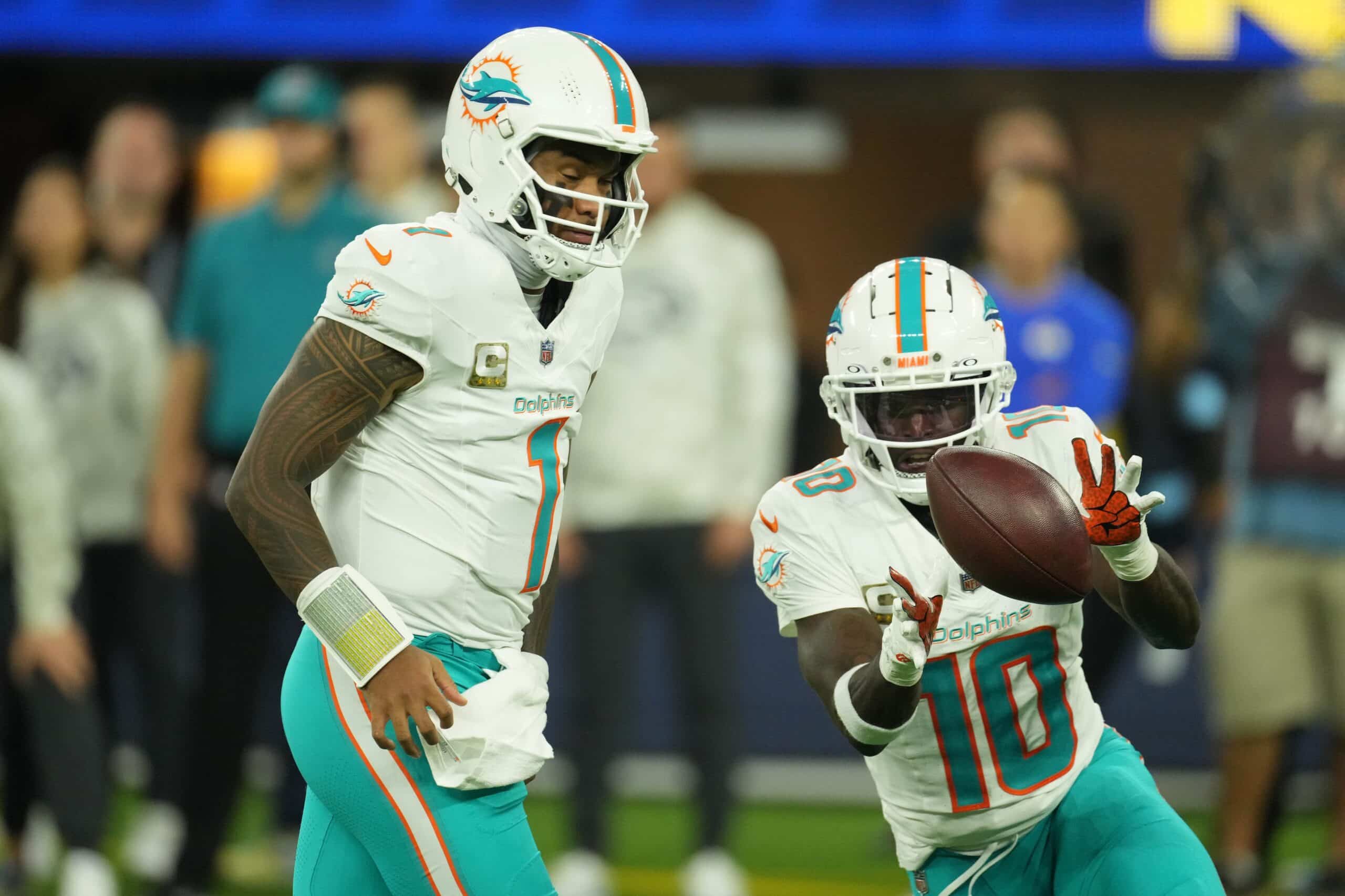 Nov 11, 2024; Inglewood, California, USA; Miami Dolphins quarterback quarterback Tua Tagovailoa (1) pitches the ball to wide receiver Tyreek Hill (10) against the Los Angeles Rams in the second half at SoFi Stadium. Mandatory Credit: Kirby Lee-Imagn Images