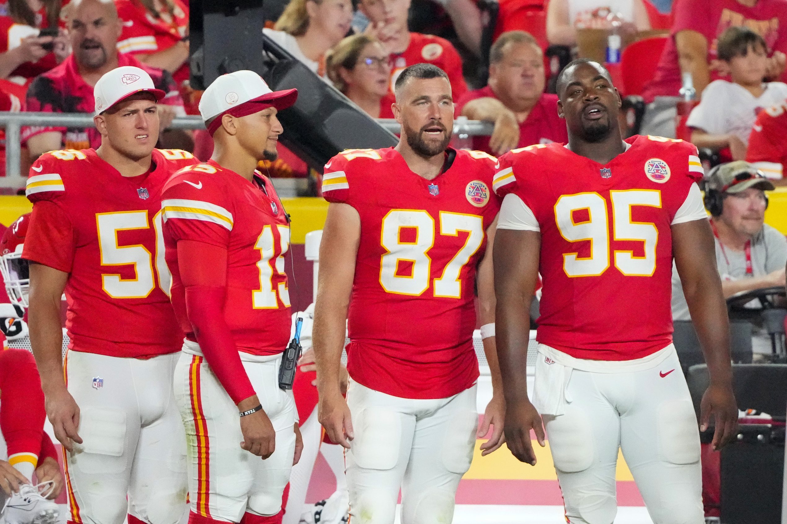 Aug 22, 2025; Kansas City, Missouri, USA; Kansas City Chiefs defensive end George Karlaftis (56) and quarterback Patrick Mahomes (15) and tight end Travis Kelce (87) and defensive tackle Chris Jones (95) watch play against the Chicago Bears during the second half of the game at GEHA Field at Arrowhead Stadium. Mandatory Credit: Denny Medley-Imagn Images
