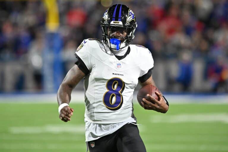Sep 7, 2025; Orchard Park, New York, USA; Baltimore Ravens quarterback Lamar Jackson (8) runs with the ball against the Buffalo Bills during the second quarter at Highmark Stadium. Mandatory Credit: Mark Konezny-Imagn Images