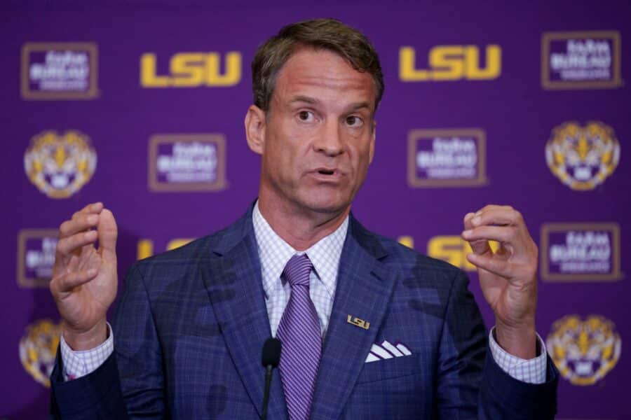 Analyst Floats Wild Coaching Shuffle that Would Impact Michigan, LSU, and Alabama 2 Dec 1, 2025; Baton Rouge, LA, USA; LSU new head coach Lane Kiffin speaks at South Stadium Club at Tiger Stadium. Mandatory Credit: Matthew Hinton-Imagn Images