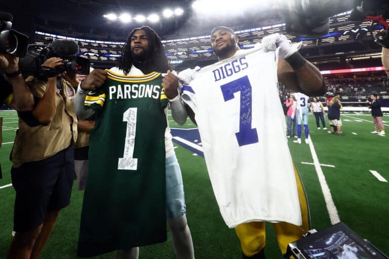 Sep 28, 2025; Arlington, Texas, USA; Green Bay Packers defensive end Micah Parsons (1) and Dallas Cowboys cornerback Trevon Diggs (7) exchange jerseys after the game at AT&T Stadium. Mandatory Credit: Kevin Jairaj-Imagn Images