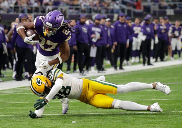 Green Bay Packers Trevon Diggs (28) puts a hit on Minnesota Vikings running back Jordan Mason (27) during their game Sunday, Jan. 4, 2026, at U.S. Bank Stadium in Minneapolis, Minnesota. © Dan Powers / USA TODAY NETWORK-Wisconsin / USA TODAY NETWORK via Imagn Images