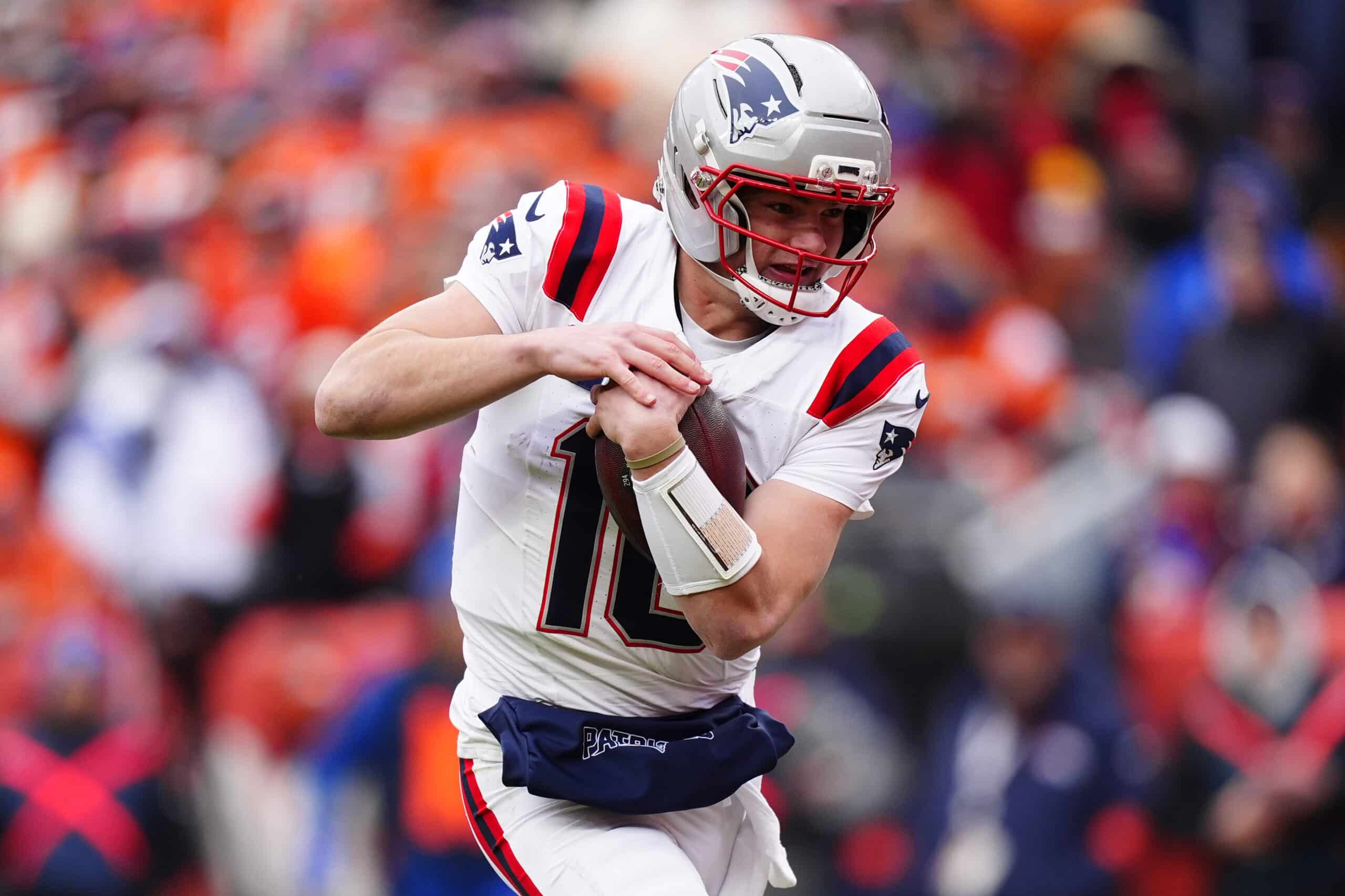 Jan 25, 2026; Denver, CO, USA; New England Patriots quarterback Drake Maye (10) rushes the ball for a touchdown against the Denver Broncos during the first half in the 2026 AFC Championship Game at Empower Field at Mile High. Mandatory Credit: Ron Chenoy-Imagn Images