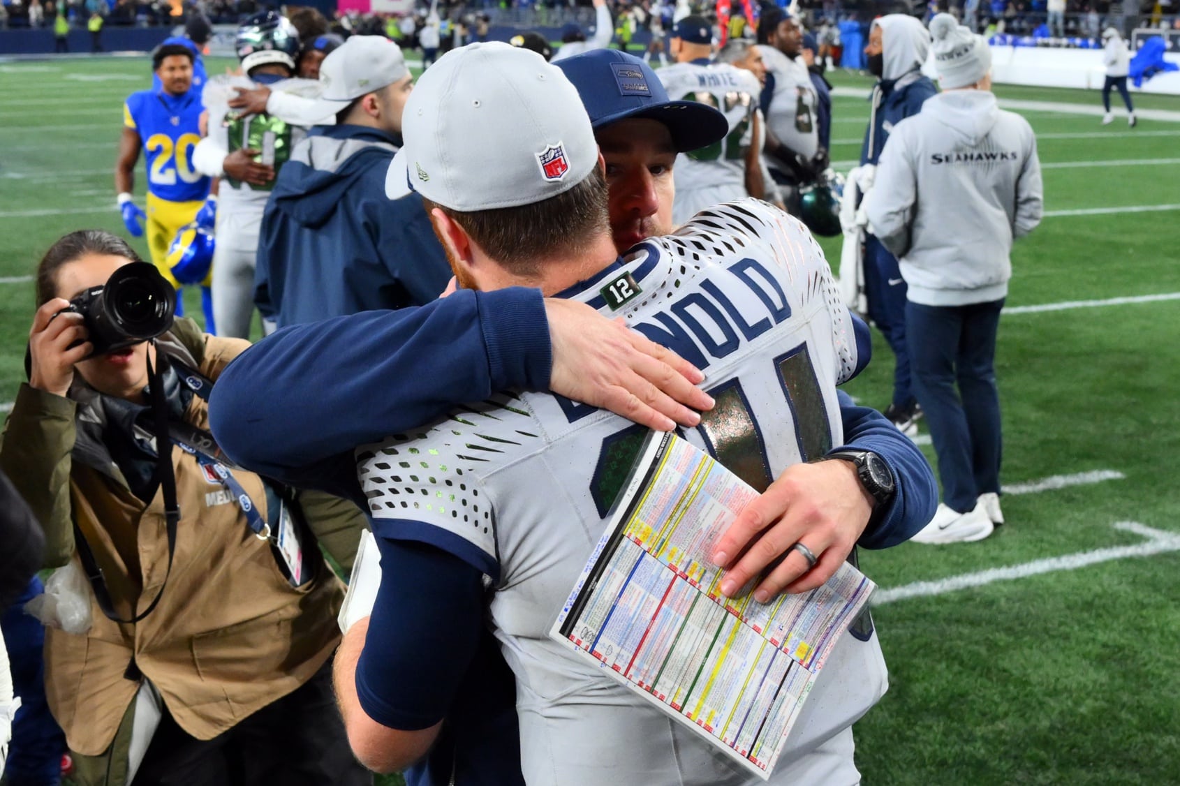 Dec 18, 2025; Seattle, Washington, USA; Seattle Seahawks quarterback Sam Darnold (14) hugs offensive coordinator Klint Kubiak after defeating the Los Angeles Rams in overtime at Lumen Field. Mandatory Credit: Steven Bisig-Imagn Images